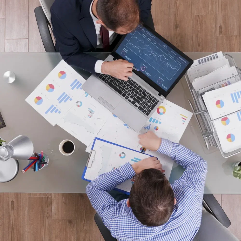 top-view-of-businessmen-analyzing-management-statistics-while-working-at-company-investments-2