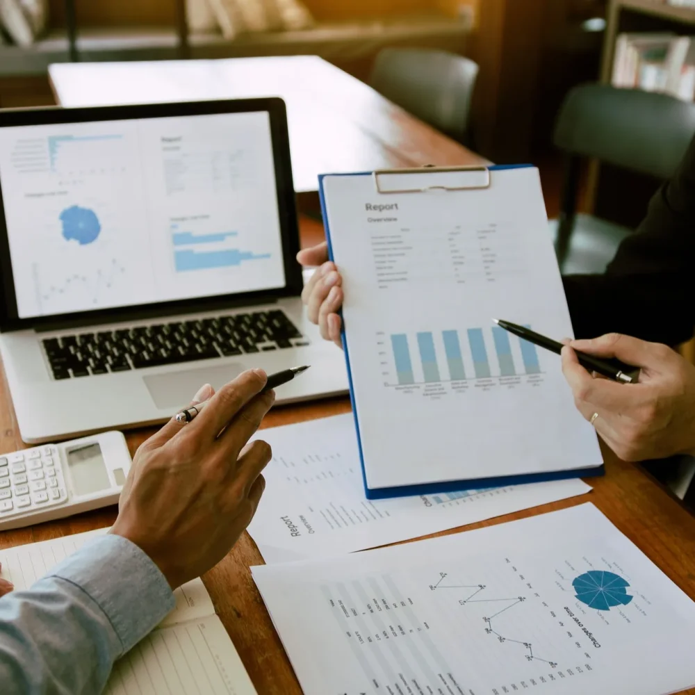 two-business-partnership-coworkers-analysis-strategy-with-discussing-a-financial-planning-graph-and-3